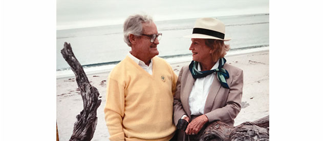 Robert Raborn and Lenore Benson Raborn stand on a beach 