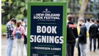 scenic photo of people near a book festival sign