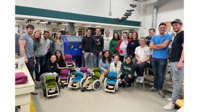 Tulane biomedical engineering students, professors and advisors with the child-size wheelchairs they made