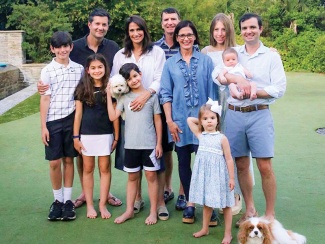 Doug Hertz (center) and members of the Hertz family pose on a lawn