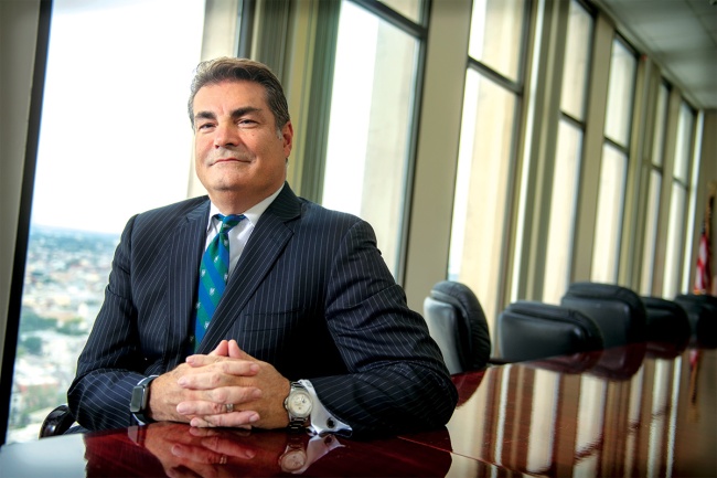 Dr. Giovanni Piedimonte seated at long conference table