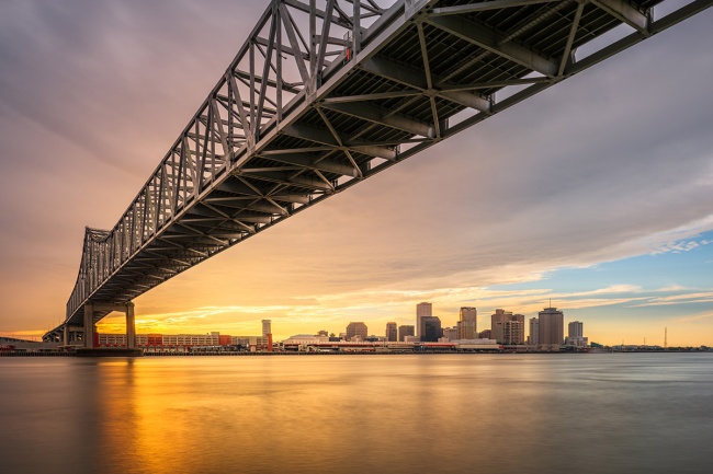 New Orleans, Louisiana, USA at Crescent City Connection Bridge over the Mississippi River at sunset