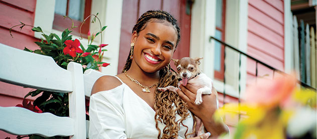 Photo of Class of 2022 graduate Mikala Nellum outside her house with dog