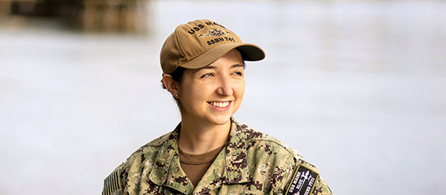 Erin Chandler stands wearing U S Navy camouflage uniform