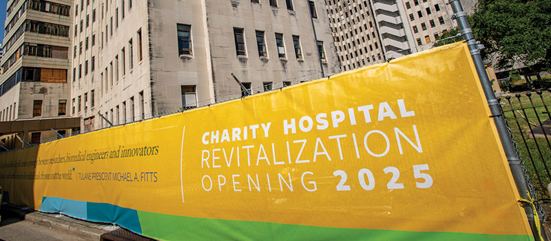 photo of fence covering announcing revitalization of Charity Hospital in 2025