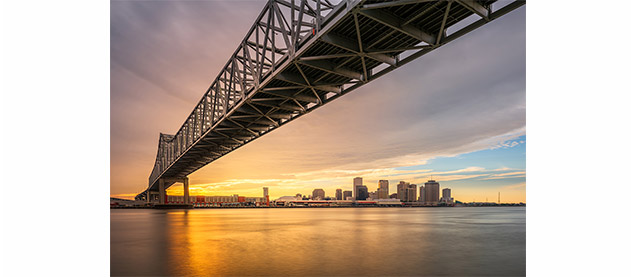 New Orleans, Louisiana, USA at Crescent City Connection Bridge over the Mississippi River at sunset