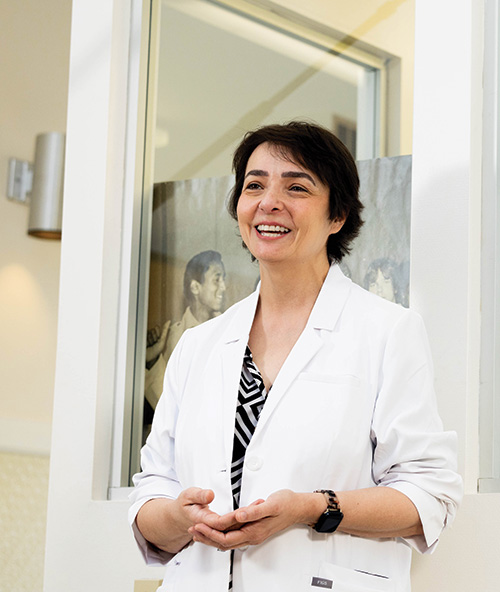 Dr. Lydia Bazzano wears a white coat in an office
