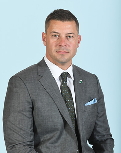 Jon Sumrall portrait in suit with Tulane pin