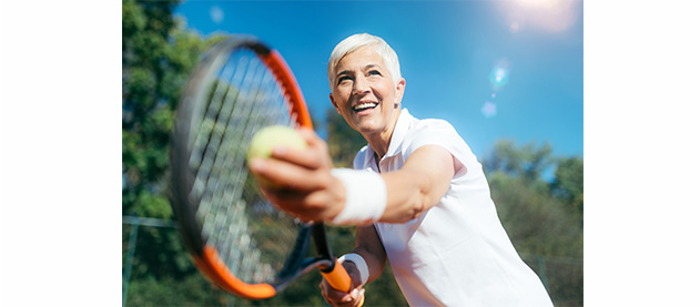 Smiling senior Woman Playing Tennis