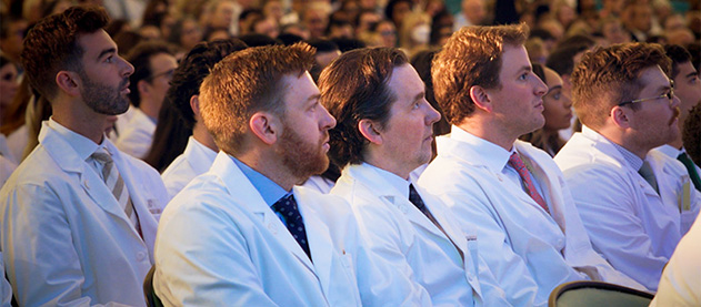 audience in white lab coats