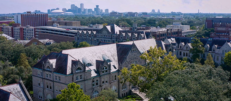 aerial view of Gibson Hall with downtown skyline in the distance