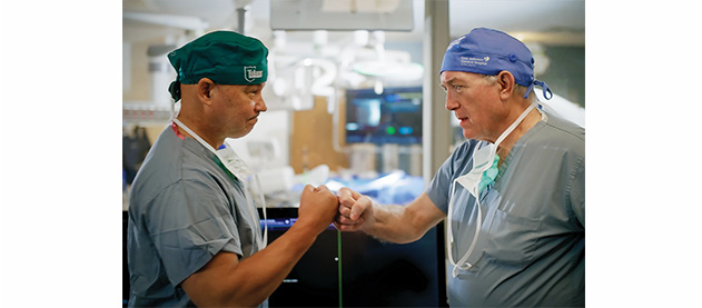 Dr. José Wiley and Dr. Harry Roach fist bump 