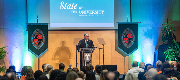 audience watches the State of University presentation