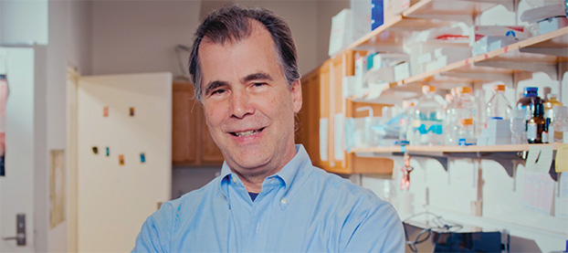 Jeffrey Tasker standing with lab equipment in background