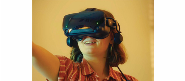 student wearing a VR headset and holding controller up