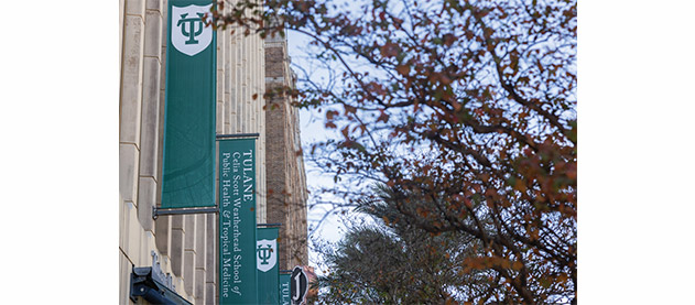 Tidewater building with green banners and fall trees