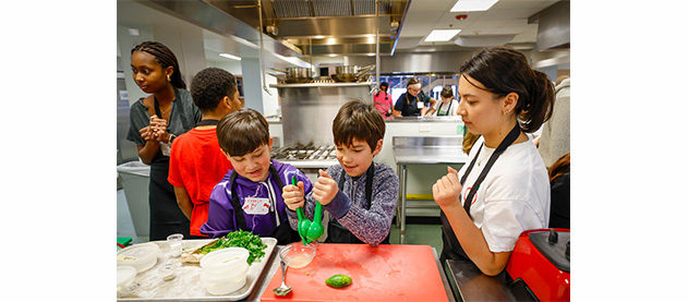 A group of kids learning to cook in a kitchen
