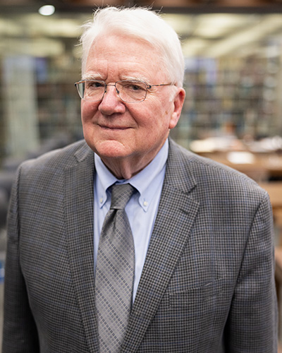 Thomas Reese portrait in a library