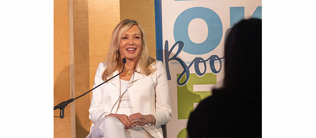 Marie Quintana speaks to audience while seated on the stage at Book Fest
