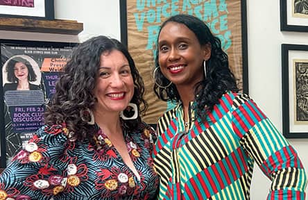 Stephanie Porras and Mia L. Bagneris smile and pose wearing brightly colored patterned clothing