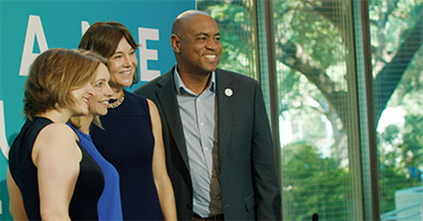 People pose for photos at a forum
