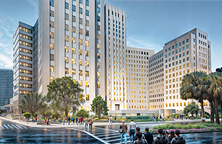 Large modern building complex on a city street with people and palm trees.