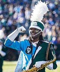 saxophone player in the Tulane Marching Band performs at a football game