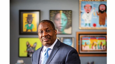 Thomas LaVeist in his office at the School of Public Health Thomas LaVeist in his office at the School of Public Health. Many paintings are displayed on the wall.