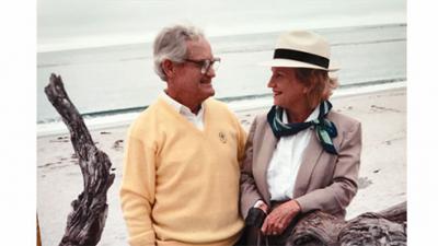 Robert Raborn and Lenore Benson Raborn stand on a beach 