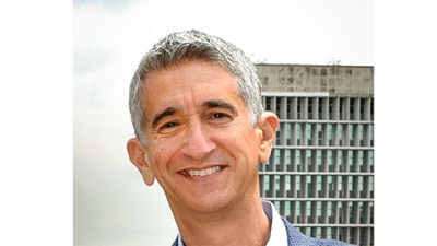 Richard M. Lerner portrait, tall building in background