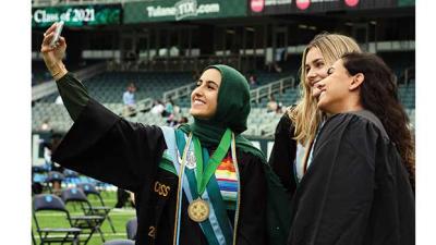 students take selfies at A. B. Freeman's 2021 commencement exercises