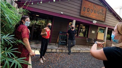 Medical students consult with restaurant staff outside Bourree's restaurant in New Orleans