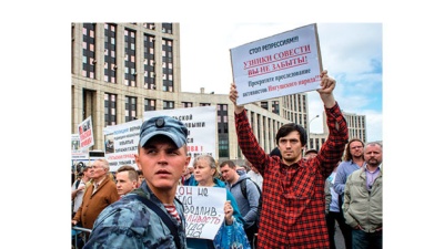 A group of people hold posters during a rally in defense of freedom of speech and journalism in central Moscow on  June 16, 2019.