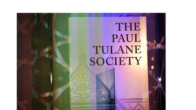 A standing banner at an event that reads "The Paul Tulane Society."