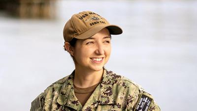 Erin Chandler stands wearing U S Navy camouflage uniform