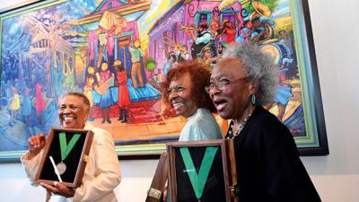 Gloria Bryant Banks, Pearlie Hardin Elloie and Marilyn S. Piper in front of their portrait by Terrance Osborne