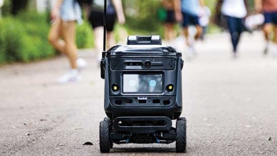 small robot on campus delivering food