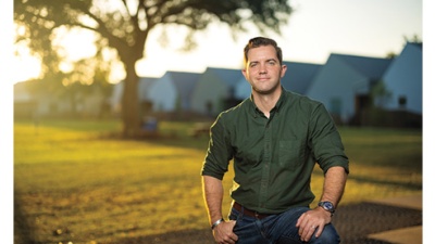 Jackson Smith stands on the grounds of Bastion Community at sunset.