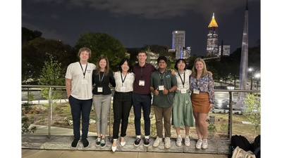 Tulane students attending the 2023 Stamps Scholars National Convention pose in Atlanta with buildings in the background.