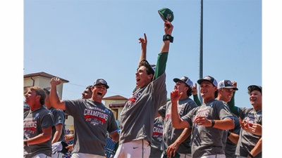 Tulane baseball players celebrate win wearing championship caps and shirts