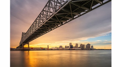 New Orleans, Louisiana, USA at Crescent City Connection Bridge over the Mississippi River at sunset