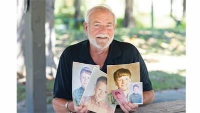 Joe Culpepper holds old family photos