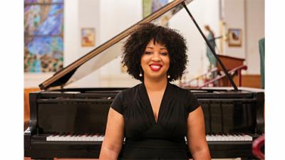 Courtney Bryan sits with open piano