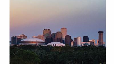 the skyline of downtown New Orleans at sunrise, as seen from the uptown campus