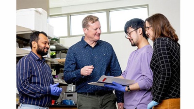 Chandrashekhar Borkar, Jonathan Fadok, Eric Le and Claire Stelly look at a document together