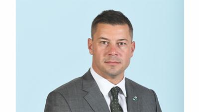 Jon Sumrall portrait in suit with Tulane pin