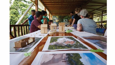 Tulane architecture students outside with renderings