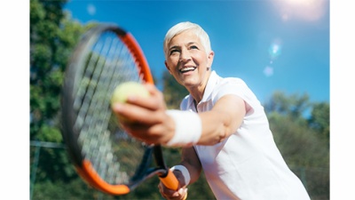 Smiling senior Woman Playing Tennis