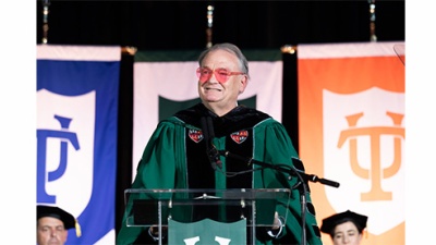 President Fitts in heart shaped sunglasses speaks to the Class of 2028