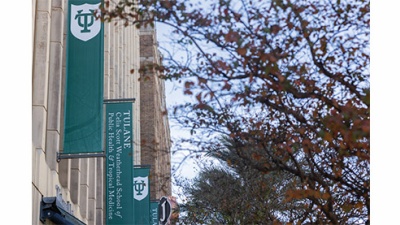 Tidewater building with green banners and fall trees
